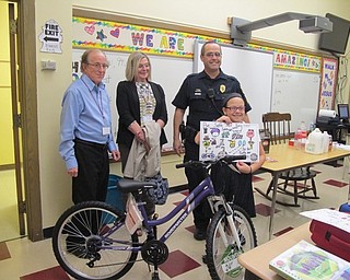 Neighbors | Alexis Bartolomucci.Isabella Thornton won first place at St. Charles for the bike safety poster contest and received a bike and helmet from Nancy Heldebrand, Chester Horlick and Sgt. Charles Hillman of the Boardman Optimist Club.