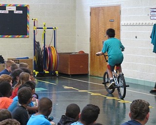 Neighbors | Alexis Bartolomucci.Ben Wang, first place winner of the bike safety contest, rode his new bike around the Robinwood Lane Elementary Gym.