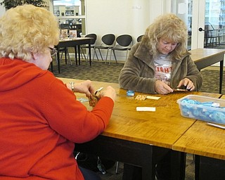 Neighbors | Alexis Bartolomucci.Guests at the Austintown library paper crafting programt on May 26 made little bags out of the materials provided.