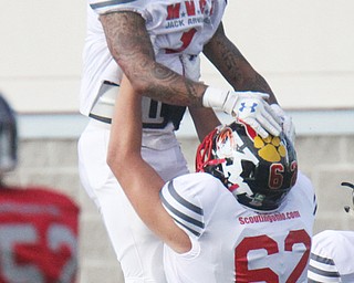 William D Lewis The vindicator  Warren Harding's Lynn Bowden(1) is lifted up by JFK's Bruce Johnson(62) aft4r scoring in 1rst QTR.