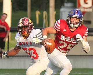 William D Lewis the vindicator   Mahoning QB Colin Sweeney (25) of Lisbon eludes Trumbull's John Spivey(53)