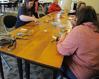 Neighbors | Alexis Bartolomucci.Guests used the materials provided to create a mini paper bag during the paper crafting event at the Austintown library.