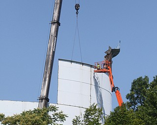        ROBERT K. YOSAY  | THE VINDICATOR..The southside landmark Water Tower on Indianola is slowly being dismantled by All Industrial Services Inc. of Boardman.  The tower.. Built in 1932 has been out of service for several years and actually  was built on a water tank that dated back to 1912..
