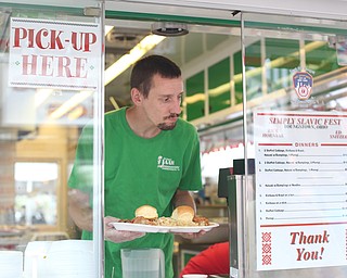 Chris Starkey of The Original Jam Concessions, holds plates of Haluski during the Simply Slavic Festival at Federal Plaza East, Saturday, June 17, 2017 in downtown Youngstown...(Nikos Frazier | The Vindicator)