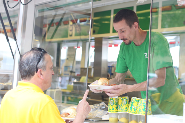 Chris Starkey of The Original Jam Concessions, serves Bill Harris of Boardman plates of Haluski during the Simply Slavic Festival at Federal Plaza East, Saturday, June 17, 2017 in downtown Youngstown...(Nikos Frazier | The Vindicator)