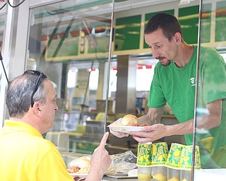 Chris Starkey of The Original Jam Concessions, serves Bill Harris of Boardman plates of Haluski during the Simply Slavic Festival at Federal Plaza East, Saturday, June 17, 2017 in downtown Youngstown...(Nikos Frazier | The Vindicator)