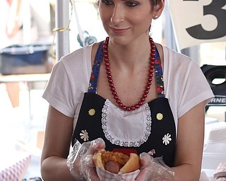 Kristan Maglis of Boardman serves a Kielbasa sub during the Simply Slavic Festival at Federal Plaza East, Saturday, June 17, 2017 in downtown Youngstown...(Nikos Frazier | The Vindicator)