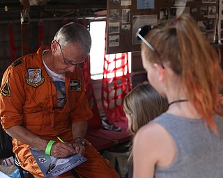 Jack McMahon, a C-123K pilot, signs autographs for a group of young girls during the Thunder Over the Valley Air Show at the Youngstown Air Reserve Station, Saturday, June 17, 2017 in Vienna...(Nikos Frazier | The Vindicator)