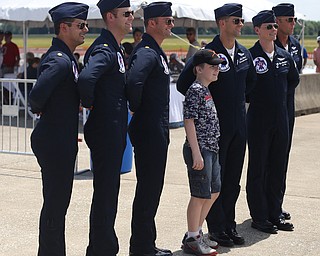 The U.S. Air Force Thunderbirds demonstration team poses for a photo with a young fan during the Thunder Over the Valley Air Show at the Youngstown Air Reserve Station, Saturday, June 17, 2017 in Vienna...(Nikos Frazier | The Vindicator)