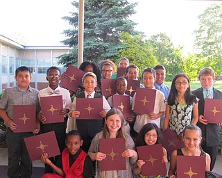Neighbors | Alexis Bartolomucci.Fourth-grade Robinwood Lane students help up their diplomas after their graduation ceremony on May 31.