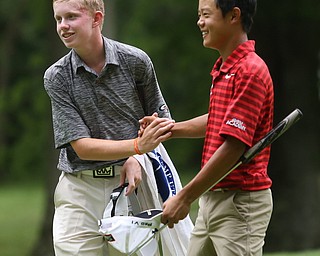 Maxwell Moldovan of Uniontown, Ohio(left) and Aaron Du of Lake Mary, Fla. shake hands after completing the third and final round of the AJGA Mill Creek Foundation Junior All-Star, Thursday, June 22, 2017 at Mill Creek Golf Course...(Nikos Frazier | The Vindicator)..