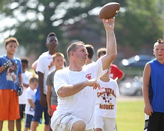 YSU Football head coach Bo Pelini prepares to throw the ball during the Cardinal Mooney Football Camp at Cardinal Mooney High School, Thursday, June 22, 2017 in Youngstown...(Nikos Frazier | The Vindicator)