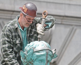     ROBERT K. YOSAY  | THE VINDICATOR..the newly-restored copper statues were returned to its roof of the courthouse..The statues, removed in October 2010, have been returned to their perch above the courthouse's main entrance where they had sat since 1909...The three hollow statues, which were restored by an Oberlin firm, are named ÒJustice,Ó on the left, ÒStrength and AuthorityÓ in the center; and ÒLawÓ on the right.