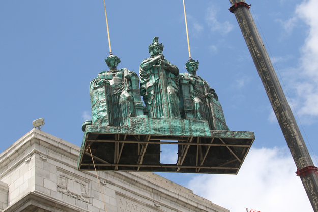     ROBERT K. YOSAY  | THE VINDICATOR..the newly-restored copper statues were returned to its roof of the courthouse..The statues, removed in October 2010, have been returned to their perch above the courthouse's main entrance where they had sat since 1909...The three hollow statues, which were restored by an Oberlin firm, are named ÒJustice,Ó on the left, ÒStrength and AuthorityÓ in the center; and ÒLawÓ on the right.