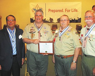 Boy Scout Councils of Mahoning and Trumbull Counties recently awarded four adult volunteers the Silver Beaver Award at the annual meeting held at St. Thomas Eastern Orthodox Church in Fairlawn, Ohio. The Silver Beaver Award is the highest award a Boy Scout Council may present to volunteers. The awards were presented to the volunteers by their sons, who are also members of the Boy Scouts. Volunteers above from left are John Barkett, Kurt Hilderbrand, Robert Guesman and David Chauvin.