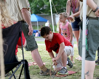Richard Morlan(9) of Boardman tries to start a fire in the Boys Scouts tent during the 19th annual Struthers Day at Mauthe Park, Thursday, June 29, 2017 in Struthers...(Nikos Frazier | The Vindicator)