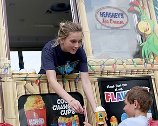 Zoe Oswald of Kona Ice hands an ice cup to Kyle Johnston(9) of Youngstown during the 19th annual Struthers Day at Mauthe Park, Thursday, June 29, 2017 in Struthers...(Nikos Frazier | The Vindicator)