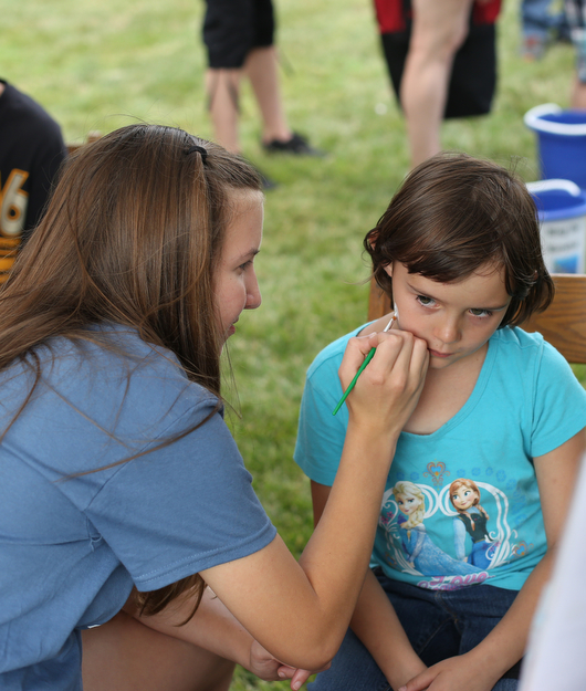 Nadeah Norton(9) has her face painted by Ellen Ethridge(13) during the 19th annual Struthers Day at Mauthe Park, Thursday, June 29, 2017 in Struthers...(Nikos Frazier | The Vindicator)