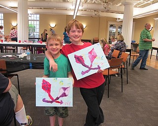 Neighbors | Alexis Bartolomucci.Children held up their finished paintings they made during the Paint Party program hosted by the Poland library.