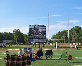 Neighbors | Alexis Bartolomucci.Community members set up chairs and blankets on the Boardman High School Spartan Stadium field as they watched highlights and prepared for the "Moana" movie.