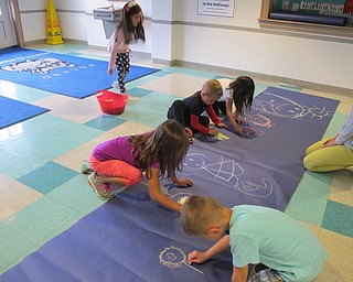 Neighbors | Alexis Bartolomucci.Students used chalk to draw a giant picture on paper during Poland North Preschool's fun day.