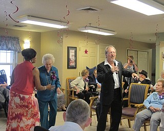 Neighbors | Alexis Bartolomucci.Dave Propri provided entertainment and sang songs for the residents and staff to dance to during their prom on June 8 at Brookdale in Austintown.