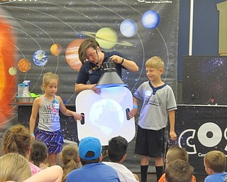 Neighbors | Alexis Bartolomucci.Children were chosen to help with different experiments during the Astounding Astronomy program from COSI on June 13 at the Boardman library.