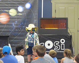 Neighbors | Alexis Bartolomucci.One of the children was chosen to dress up in different outfits for the road trip the children were taking during the COSI program.