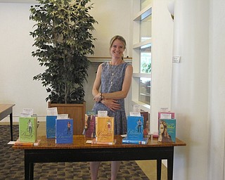 Neighbors | Alexis Bartolomucci.Sara Shepard stood with some of her books before her presentation at the Austintown library on June 13.