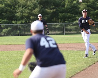 Roth second baseman Mikey Grazier(21) throws to first baseman Robby Russo(42) during the 2nd inning as Roth Brothers takes on Baird Brothers, Friday, June 30, 2017 at Bob Cene Park. Play was stopped in the 6th inning due to a lightning delay then never resumed because of heavy rain...(Nikos Frazier | The Vindicator)..