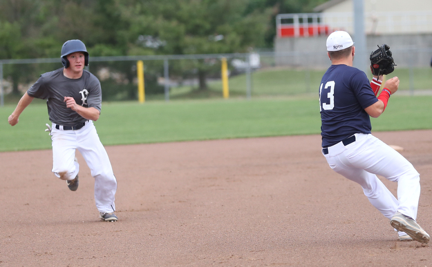 Baird runner Dom Bucko(5) looks at Roth third baseman Tyler Srbinovich(13) during the 3rd inning as Roth Brothers takes on Baird Brothers, Friday, June 30, 2017 at Bob Cene Park. Play was stopped in the 6th inning due to a lightning delay then never resumed because of heavy rain...(Nikos Frazier | The Vindicator)..