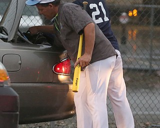 Asst. Mgr. Mike Grazier and Roth second baseman Mikey Grazier(21) pack up their car after play was stopped in the 6th inning due to a lightning delay then never resumed because of heavy rain during a Class B baseball game between Roth Brothers and on Baird Brothers, Friday, June 30, 2017 at Bob Cene Park...(Nikos Frazier | The Vindicator)..