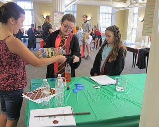 Neighbors | Alexis Bartolomucci.Children at the Hogwarts Summer School program at the Poland library mixed ingredients to see how different liquids interact with each other.
