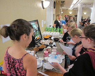 Neighbors | Alexis Bartolomucci.Children created their own wands and enjoyed wizard snacks at the Hogwarts Summer School program at the Poland library.