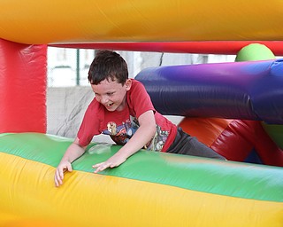 Nathan Porter(7) of Boardman jumps through the 61 ft obstacle bounce house during the Canfield Rotary Fireworks Fest at the Canfield Fair Grounds, Saturday, July 1, 2017 in Canfield...(Nikos Frazier | The Vindicator)