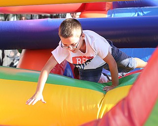 Shane Ashburn(7) of Boardman jumps through the 61 ft obstacle bounce house during the Canfield Rotary Fireworks Fest at the Canfield Fair Grounds, Saturday, July 1, 2017 in Canfield...(Nikos Frazier | The Vindicator)