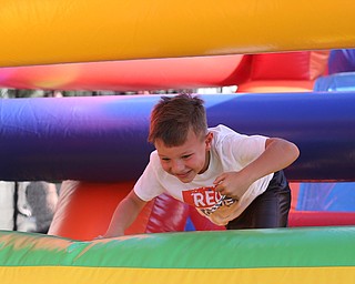 Dominic Krut(7) of Boardman jumps through the 61 ft obstacle bounce house during the Canfield Rotary Fireworks Fest at the Canfield Fair Grounds, Saturday, July 1, 2017 in Canfield...(Nikos Frazier | The Vindicator)