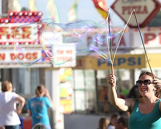 Ashley Blose the "Bubble Ferry" makes bubbles with her bubble sticks during the Canfield Rotary Fireworks Fest at the Canfield Fair Grounds, Saturday, July 1, 2017 in Canfield...(Nikos Frazier | The Vindicator)