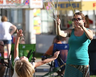 Ashley Blose the "Bubble Ferry" makes bubbles with her bubble sticks during the Canfield Rotary Fireworks Fest at the Canfield Fair Grounds, Saturday, July 1, 2017 in Canfield...(Nikos Frazier | The Vindicator)
