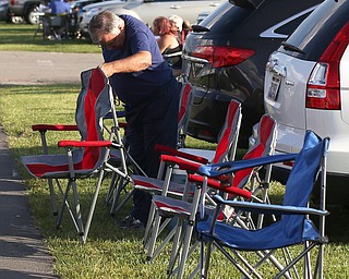 Paul Rogers of Clearwater, Fla. lays out his chairs before the fireworks during the Canfield Rotary Fireworks Fest at the Canfield Fair Grounds, Saturday, July 1, 2017 in Canfield...(Nikos Frazier | The Vindicator)