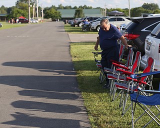 Paul Rogers of Clearwater, Fla. lays out his chairs before the fireworks during the Canfield Rotary Fireworks Fest at the Canfield Fair Grounds, Saturday, July 1, 2017 in Canfield...(Nikos Frazier | The Vindicator)