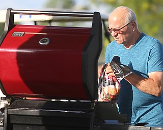 Joe Fusco of Canfield starts BBQ'n before the fireworks during the Canfield Rotary Fireworks Fest at the Canfield Fair Grounds, Saturday, July 1, 2017 in Canfield...(Nikos Frazier | The Vindicator)