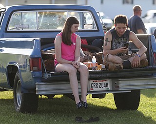 Rocky Ritchie and Heather Harpster wait for the start of the fireworks during the Canfield Rotary Fireworks Fest at the Canfield Fair Grounds, Saturday, July 1, 2017 in Canfield...(Nikos Frazier | The Vindicator)