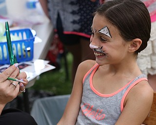 Isabel Greco(8) of Poland smiles as she looks at her reflection after having her face painted by Vonda Keeler of Poland Village Baptist Church during the 11th annual Celebrate Poland weekend at Village Hall, Saturday, July 1, 2017 in Poland...(Nikos Frazier | The Vindicator)