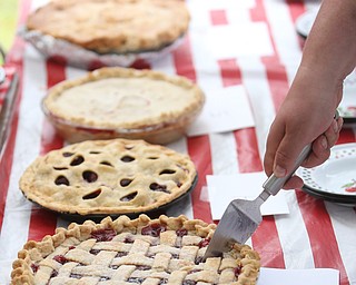 Judge Steve Murphy, Bakery Manager at the Poland Giant Eagle, slices up a cherry pie during the cherry pie baking contest during the 11th annual Celebrate Poland weekend at Village Hall, Saturday, July 1, 2017 in Poland...(Nikos Frazier | The Vindicator)