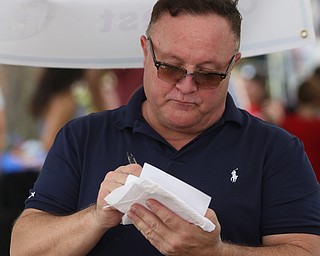 Judge and Chef David Armstrong scores a cherry pie during the cherry pie baking contest during the 11th annual Celebrate Poland weekend at Village Hall, Saturday, July 1, 2017 in Poland...(Nikos Frazier | The Vindicator)