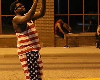 Justin Howard of Youngstown plays catch with a football before the Fourth of July Fireworks at the Covelli Centre, Tuesday, July 4, 2017 in Youngstown...(Nikos Frazier | The Vindicator)