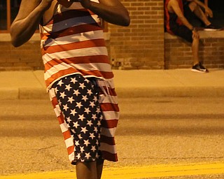 Justin Howard of Youngstown plays catch with a football before the Fourth of July Fireworks at the Covelli Centre, Tuesday, July 4, 2017 in Youngstown...(Nikos Frazier | The Vindicator)