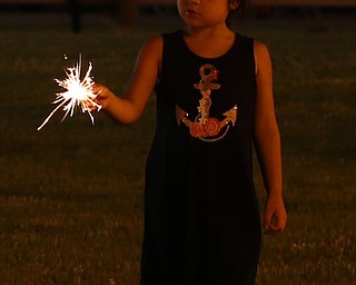 Riley Kutsch(5) of Girard plays with a sparkler before the Fourth of July Fireworks at the Covelli Centre, Tuesday, July 4, 2017 in Youngstown...(Nikos Frazier | The Vindicator)