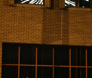 A group watches the fireworks display as the explosion is reflected in the window of a Front St. business during the Fourth of July Fireworks at the Covelli Centre, Tuesday, July 4, 2017 in Youngstown...(Nikos Frazier | The Vindicator)